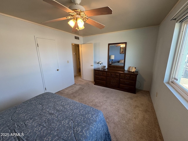 bedroom with ceiling fan, crown molding, visible vents, and light colored carpet