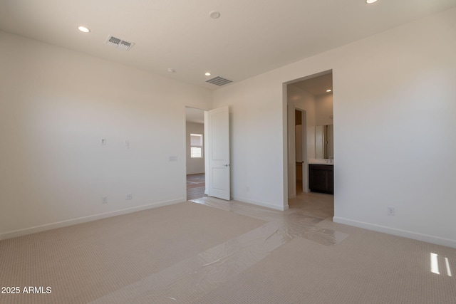17966 W Long Lake Rd, Goodyear, AZ 85338 - unfurnished bedroom with recessed lighting, light carpet, and connected bathroom
