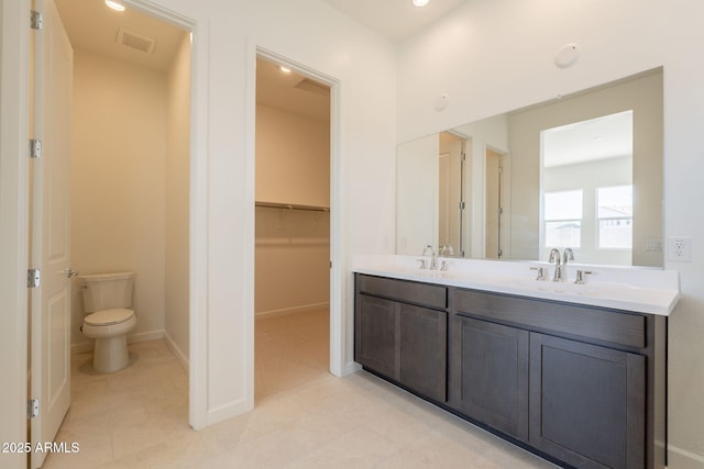 17966 W Long Lake Rd, Goodyear, AZ 85338 - bathroom featuring double vanity, tile patterned flooring, a spacious closet, and recessed lighting