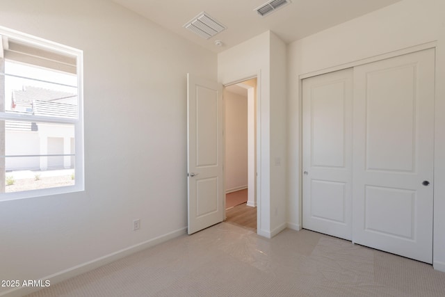 17966 W Long Lake Rd, Goodyear, AZ 85338 - unfurnished bedroom featuring light carpet and a closet