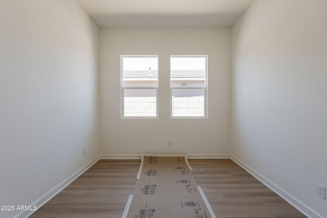 17966 W Long Lake Rd, Goodyear, AZ 85338 - empty room with light wood-style floors