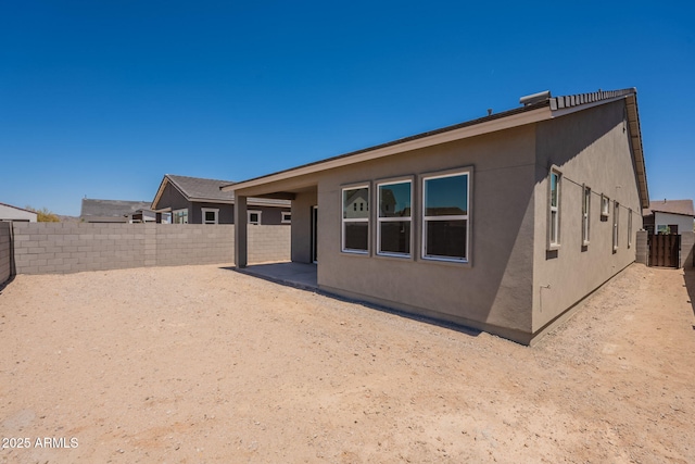 17966 W Long Lake Rd, Goodyear, AZ 85338 - rear view of property featuring a fenced backyard, stucco siding, and a patio