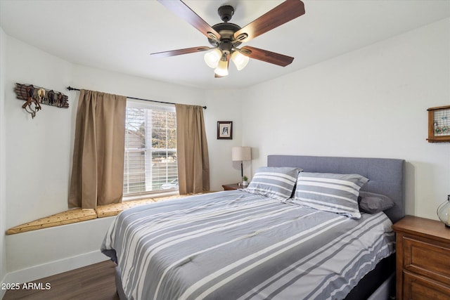 bedroom with dark wood-type flooring and ceiling fan