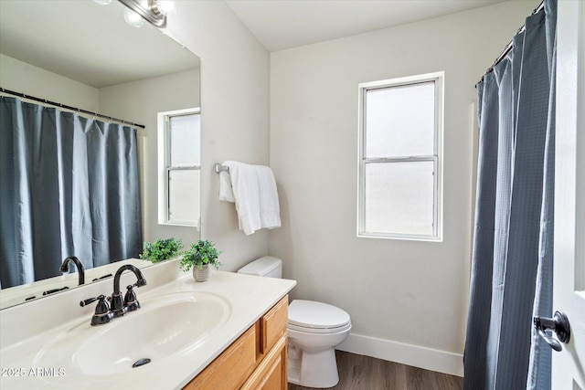 bathroom featuring vanity, wood-type flooring, and toilet