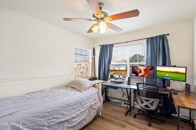 bedroom featuring ceiling fan and hardwood / wood-style floors