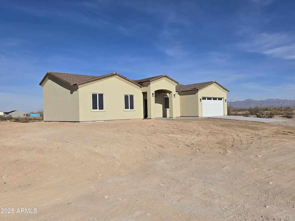 view of front of home featuring a mountain view and a garage