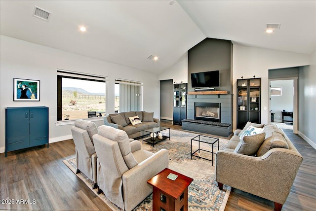 living room featuring high vaulted ceiling and dark hardwood / wood-style floors