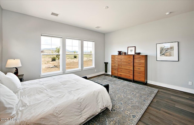 bedroom with dark hardwood / wood-style flooring