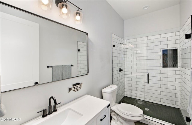 bathroom with toilet, vanity, and walk in shower