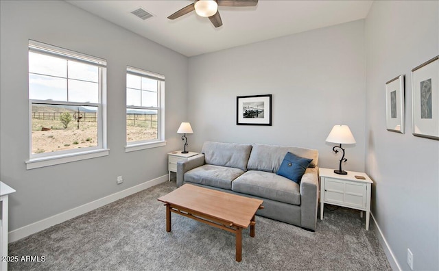 carpeted living room with ceiling fan