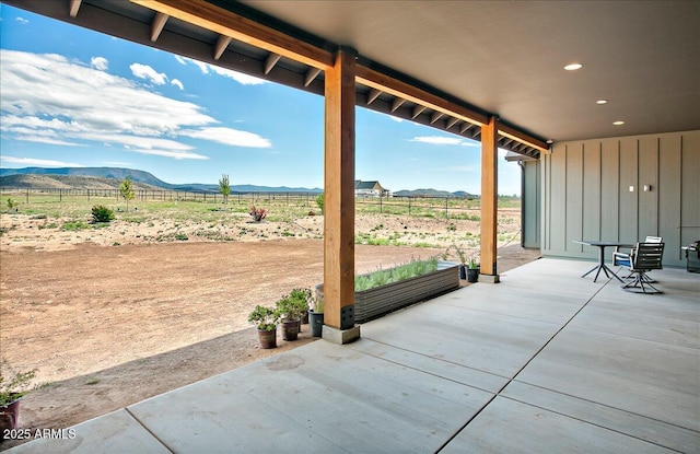 view of patio / terrace with a mountain view and a rural view