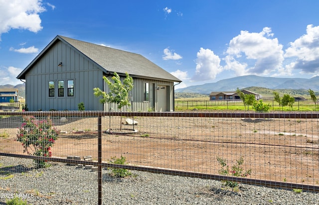 view of side of home with a mountain view and a garage