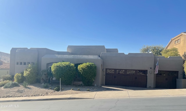 southwest-style home featuring a garage