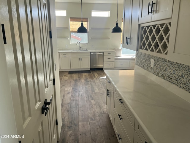 kitchen with dishwasher, white cabinets, decorative backsplash, decorative light fixtures, and dark hardwood / wood-style flooring