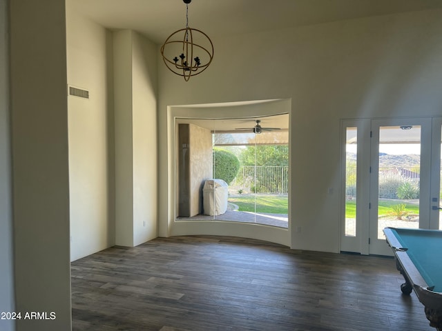 interior space with a notable chandelier and dark hardwood / wood-style flooring