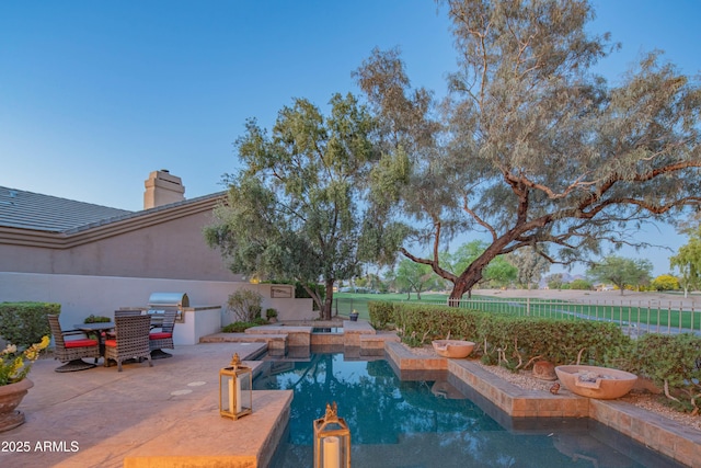 9905 N 78th Pl, Scottsdale, AZ 85258 - view of pool with a fenced backyard, exterior kitchen, a fenced in pool, and a patio