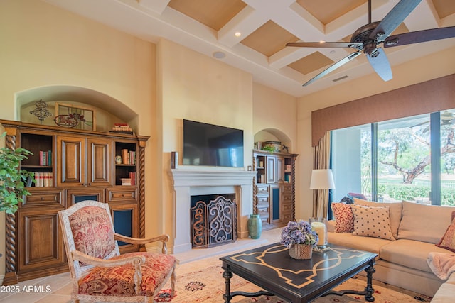 9905 N 78th Pl, Scottsdale, AZ 85258 - living area featuring a towering ceiling, a fireplace with raised hearth, visible vents, beamed ceiling, and coffered ceiling