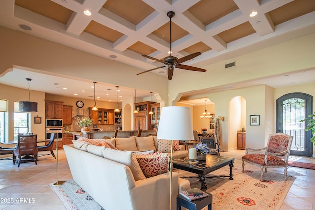 9905 N 78th Pl, Scottsdale, AZ 85258 - living room with arched walkways, visible vents, recessed lighting, a high ceiling, and coffered ceiling