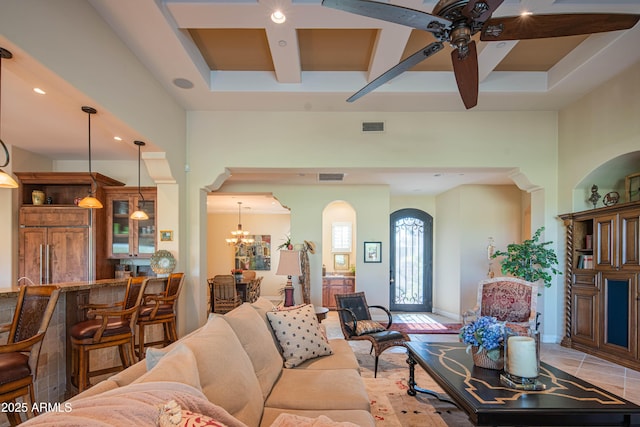 9905 N 78th Pl, Scottsdale, AZ 85258 - living room featuring arched walkways, visible vents, ceiling fan with notable chandelier, and coffered ceiling