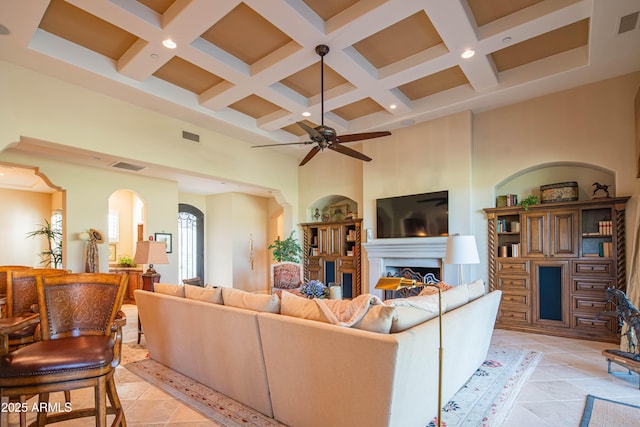 9905 N 78th Pl, Scottsdale, AZ 85258 - living room featuring a towering ceiling, a ceiling fan, visible vents, beamed ceiling, and coffered ceiling