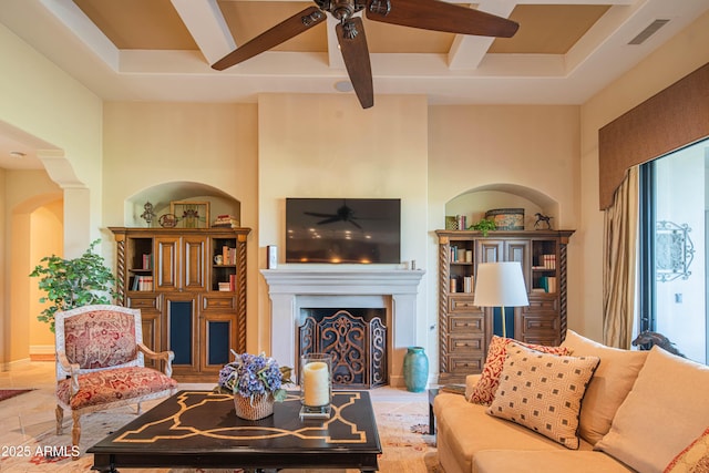 9905 N 78th Pl, Scottsdale, AZ 85258 - living room with visible vents, arched walkways, a ceiling fan, a fireplace, and beamed ceiling