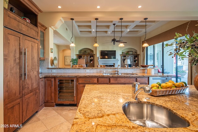 9905 N 78th Pl, Scottsdale, AZ 85258 - kitchen with brown cabinets, a sink, a ceiling fan, and wine cooler