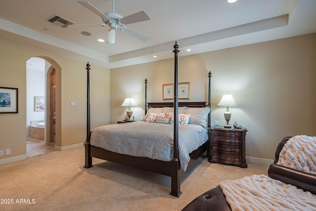 9905 N 78th Pl, Scottsdale, AZ 85258 - bedroom featuring visible vents, arched walkways, a tray ceiling, recessed lighting, and light colored carpet