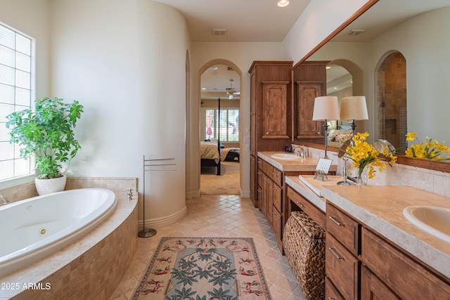 9905 N 78th Pl, Scottsdale, AZ 85258 - ensuite bathroom with a whirlpool tub, double vanity, tile patterned flooring, connected bathroom, and a sink