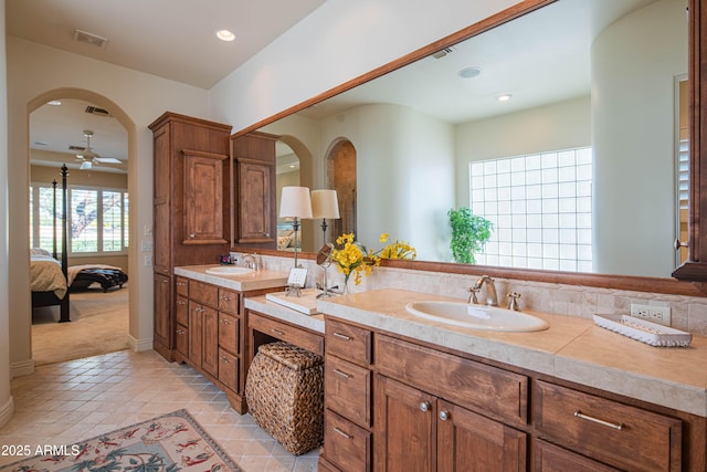 9905 N 78th Pl, Scottsdale, AZ 85258 - bathroom featuring double vanity, visible vents, a sink, and connected bathroom