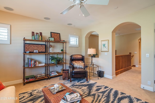 9905 N 78th Pl, Scottsdale, AZ 85258 - sitting room featuring baseboards, arched walkways, ceiling fan, an upstairs landing, and carpet flooring