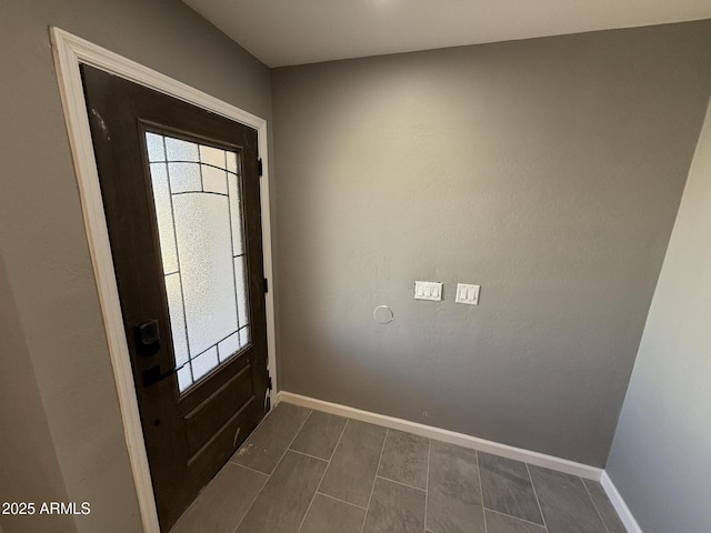 5042 S 22nd St, Phoenix, AZ 85040 - foyer entrance with baseboards and dark tile patterned floors