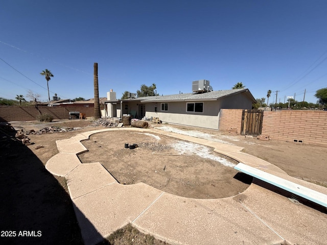 5042 S 22nd St, Phoenix, AZ 85040 - back of property with cooling unit, stucco siding, and a patio