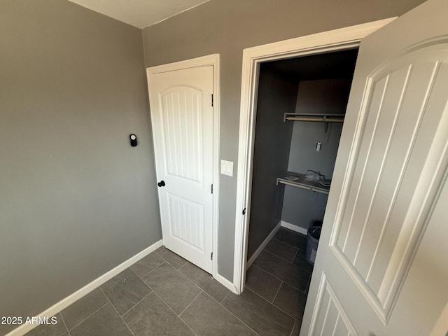 5042 S 22nd St, Phoenix, AZ 85040 - washroom with baseboards and dark tile patterned floors