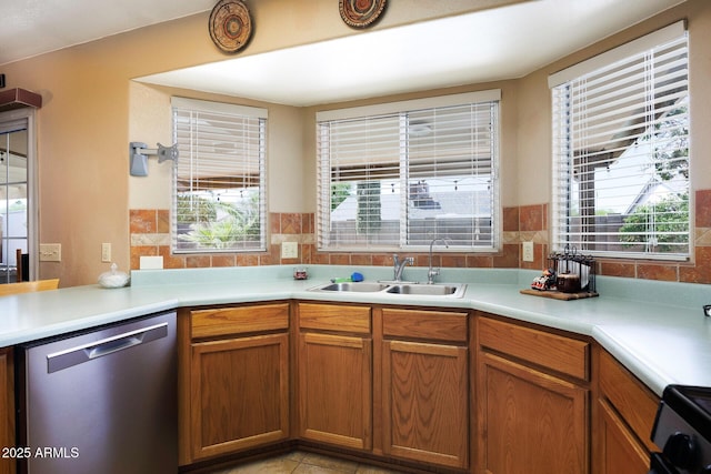 1623 E Krystal St, Casa Grande, AZ 85122 - kitchen with brown cabinetry, dishwasher, a sink, light countertops, and light tile patterned floors