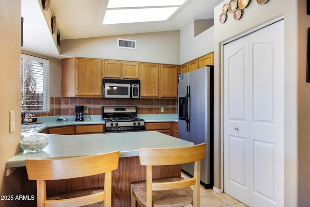 1623 E Krystal St, Casa Grande, AZ 85122 - kitchen with visible vents, decorative backsplash, lofted ceiling, light countertops, and stainless steel appliances