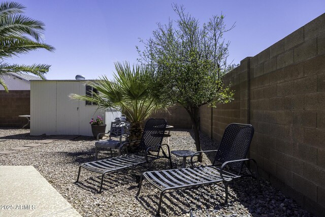 1623 E Krystal St, Casa Grande, AZ 85122 - view of patio / terrace with a fenced backyard and an outbuilding