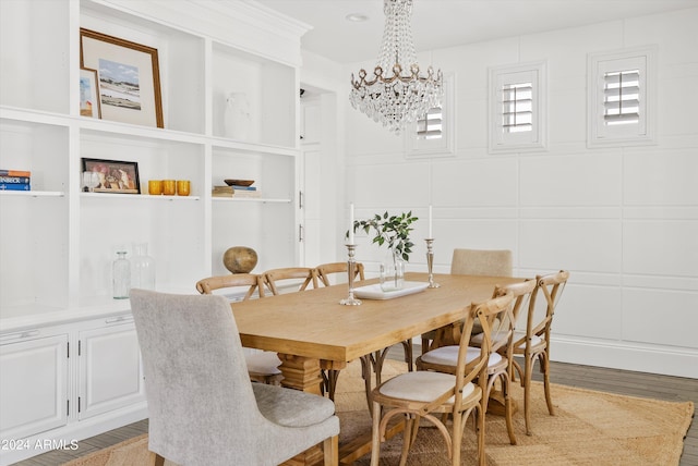 dining room with hardwood / wood-style floors and an inviting chandelier