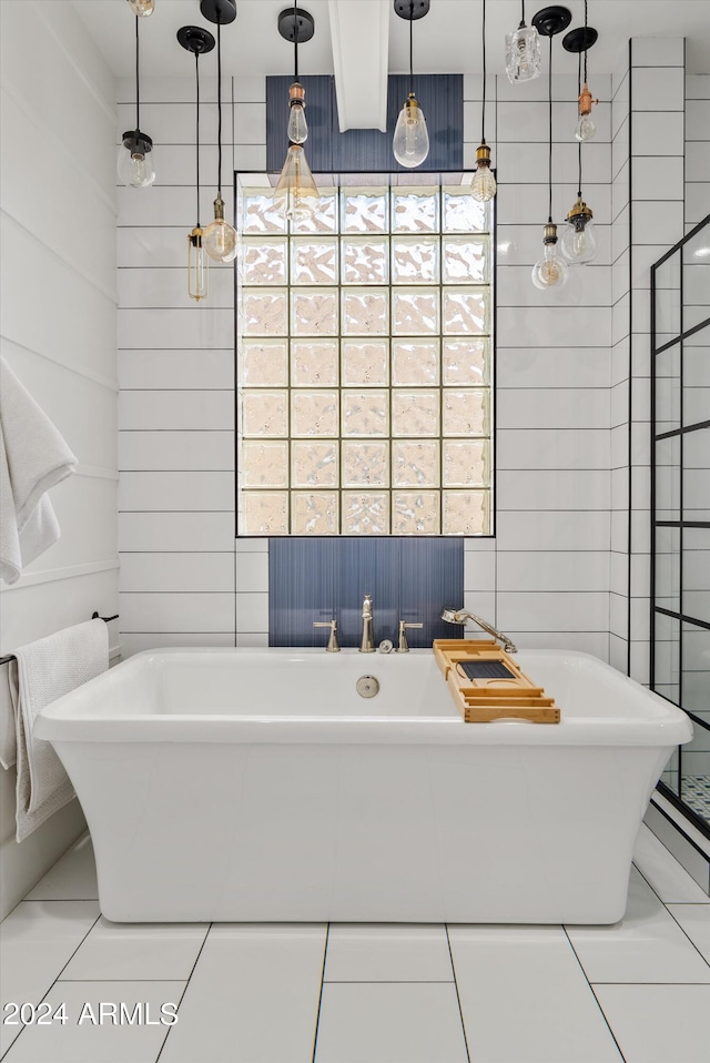 bathroom with a tub and tile patterned flooring