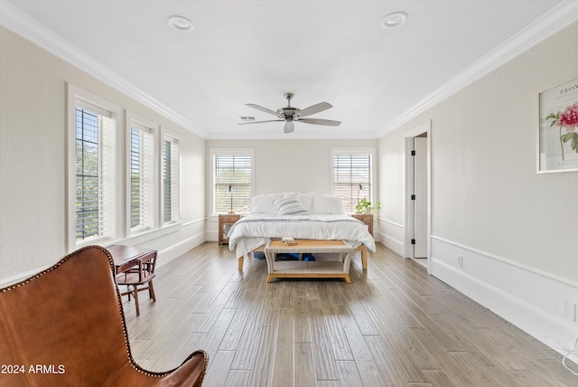 bedroom with ornamental molding, light wood-type flooring, and ceiling fan