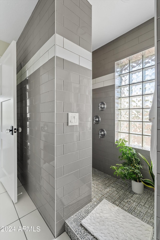 bathroom featuring a tile shower and tile patterned flooring