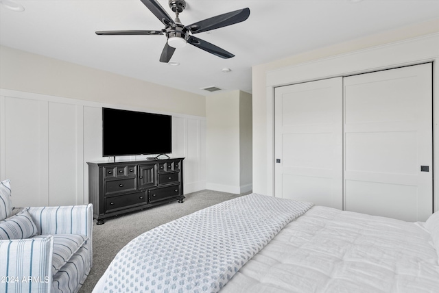 carpeted bedroom with a closet and ceiling fan