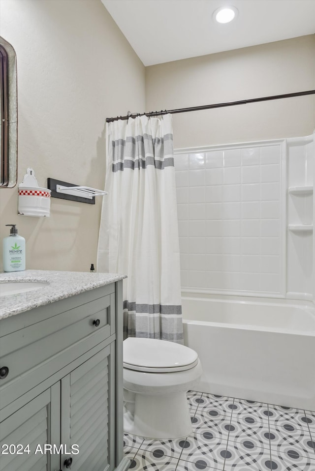 full bathroom featuring vanity, toilet, tile patterned floors, and shower / bath combo