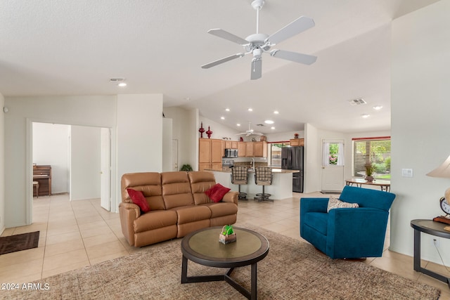 tiled living room featuring vaulted ceiling and ceiling fan