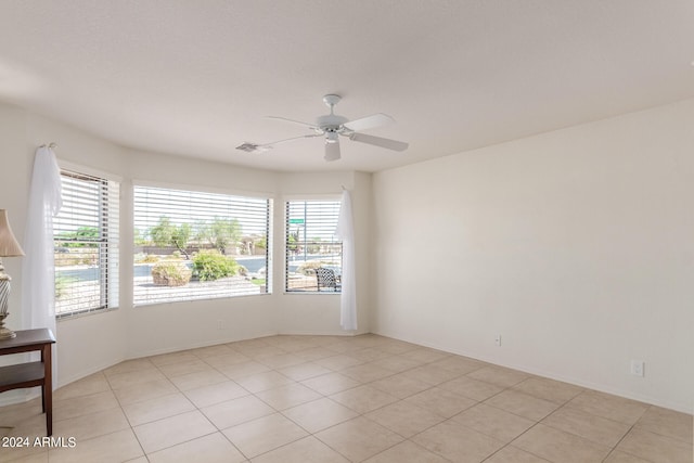 empty room featuring light tile patterned flooring and a wealth of natural light