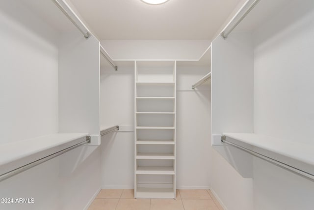 spacious closet with light tile patterned floors