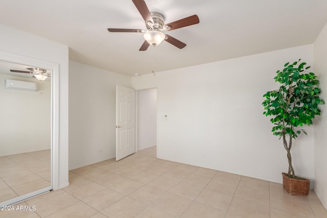 interior space featuring light tile patterned flooring, a wall mounted AC, and ceiling fan