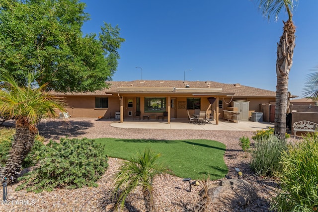 back of property featuring a lawn and a patio