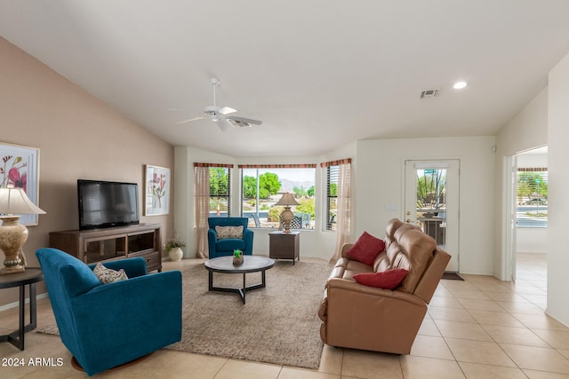 living room with light tile patterned floors, lofted ceiling, ceiling fan, and a healthy amount of sunlight