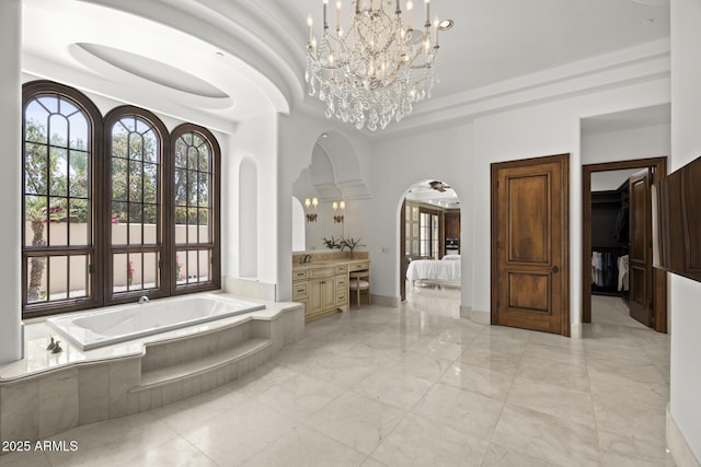 6852 E Fanfol Dr, Paradise Valley, AZ 85253 - ensuite bathroom with a bath, vanity, marble finish floor, an inviting chandelier, and ensuite bath