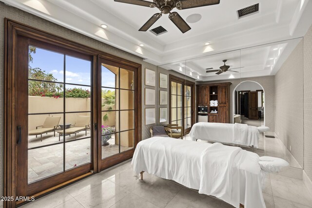 6852 E Fanfol Dr, Paradise Valley, AZ 85253 - tiled bedroom with arched walkways, a raised ceiling, visible vents, and recessed lighting